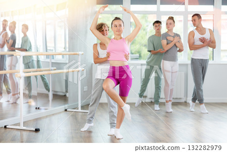 Boy and girl in pair train to perform ballet dance during rehearsal in studio Boy and girl in pair train to perform ballet dance during rehearsal in studio 132282979