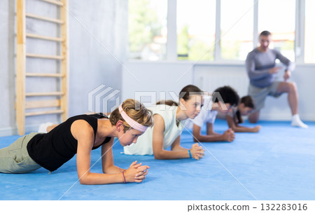 Child pupils performs plank exercises Child pupils performs plank exercises 132283016