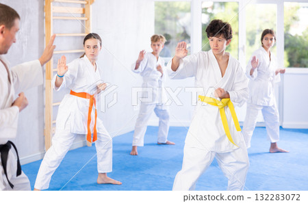 Group of children train karate techniques 132283072