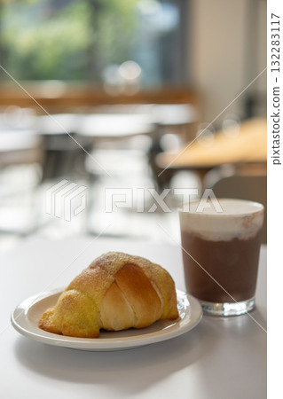 Salted bread with sweet sauce served on plate, with a glass of iced chocolate on the table Salted bread with sweet sauce served on plate, with a glass of iced chocolate on the table 132283117