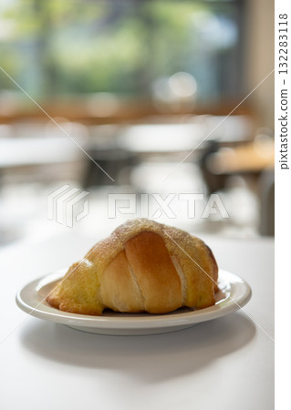 Salted bread with sweet sauce on the top, served on plate on the table 132283118