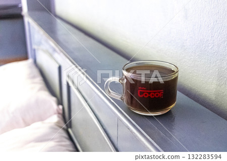Glass cup of black coffee on the bed at home. 132283594