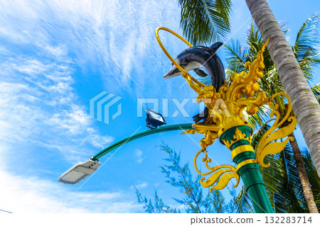 Golden green white street lantern with ornate dolphin figure in Thailand. 132283714