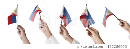 The Philippines flag in hand in different angles on a white background 132286033
