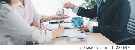 Panorama of real estate deal with house models, key handover, cash money, and calculator on desk, symbolizing property investment, mortgage loan, housing purchase, and financial planning success. Panorama of real estate deal with house models, key handover, cash money, and calculator on desk, symbolizing property investment, mortgage loan, housing purchase, and financial planning success. 132286472