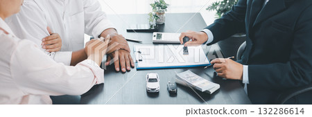 Panorama of car loan approval with businessman stamping contract, cash, vehicle model and key on desk, concept of finance, insurance, leasing, trust, confirmation and business deal. car loan approval Panorama of car loan approval with businessman stamping contract, cash, vehicle model and key on desk, concept of finance, insurance, leasing, trust, confirmation and business deal. car loan approval 132286614