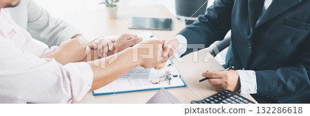 Panorama of successful real estate deal with handshake, contract, house key and calculator on desk, symbolizing mortgage loan approval, property investment, housing purchase and financial agreement. 132286618