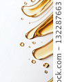 Golden liquid droplets on smooth white surface with flowing curves 132287663