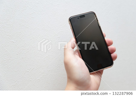 Male hand holding a smartphone Male hand holding a smartphone 132287906