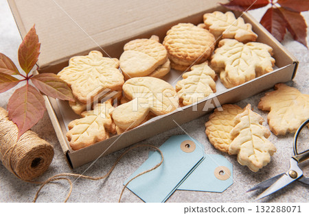 Autumn shaped cookies baking in cardboard gift box Autumn shaped cookies baking in cardboard gift box 132288071