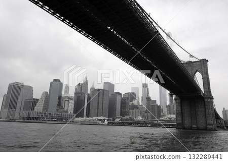 New York: Manhattan from under the Brooklyn Bridge on a cloudy day New York: Manhattan from under the Brooklyn Bridge on a cloudy day 132289441