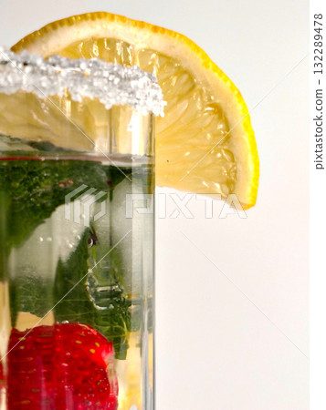 Cocktail glass with a sugared rim, lemon slice, mint, and strawberry. Cocktail glass with a sugared rim, lemon slice, mint, and strawberry. 132289478