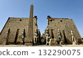 Facade of an ancient temple with stone statues and towers, magnificent desert architecture and tourist theme 132290075