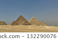 Desert landscape with ancient pyramids lined up side by side - a sunny day's scene with a sense of tourism and adventure 132290076