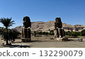 Two colossal statues standing in the desert: a magnificent historical landmark and tourist spot 132290079