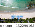 Blue umbrellas with tourists relaxing at Kata beach in Phuket, Thailand. 132290168
