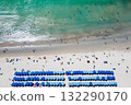 Blue umbrellas with tourists relaxing at Kata beach in Phuket, Thailand. 132290170