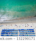 Blue umbrellas with tourists relaxing at Kata beach in Phuket, Thailand. 132290171