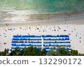 Blue umbrellas with tourists relaxing at Kata beach in Phuket, Thailand. 132290172