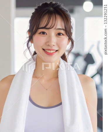 Fitness portrait of a woman with a towel around her neck Fitness portrait of a woman with a towel around her neck 132291251