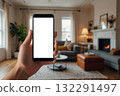 Hand holding a smartphone with a blank white screen in a softly living room 132291497