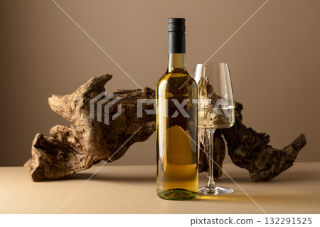 White wine and old snag on a beige background. 132291525