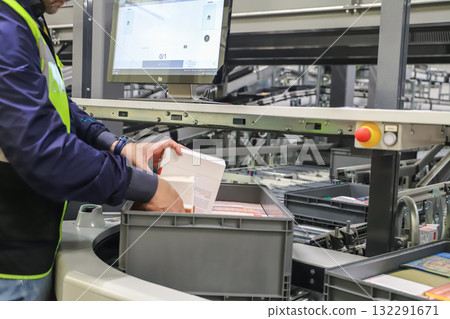 packing line in a logistics warehouse. conveyor belt in a modern production line packing line in a logistics warehouse. conveyor belt in a modern production line 132291671