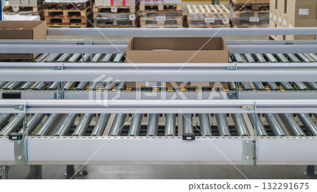 packing line in a logistics warehouse. conveyor belt in a modern production line packing line in a logistics warehouse. conveyor belt in a modern production line 132291675