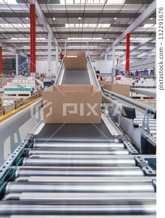 packing line in a logistics warehouse. conveyor belt in a modern production line 132291676