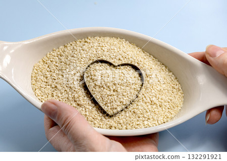 Sesame seeds in a white bowl with a heart Sesame seeds in a white bowl with a heart 132291921
