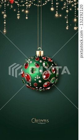 Decorative green Christmas ornament with red and green jewels hanging against a dark background 132292120