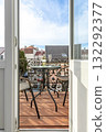 Open Door to Cozy Balcony with Wine and City View 132292377