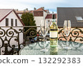 Wine Bottle and Glasses on Balcony Table with City View 132292383