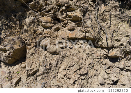 A detailed view of a quarry that is no longer in use. A detailed view of the crumbling remains of stone quarrying. A detailed view of a quarry that is no longer in use. A detailed view of the crumbling remains of stone quarrying. 132292850