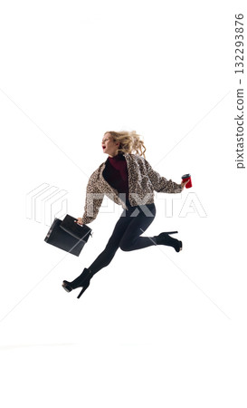 Dynamic woman in leopard jacket jumping with coffee cup and black shopping bag on white Dynamic woman in leopard jacket jumping with coffee cup and black shopping bag on white 132293876