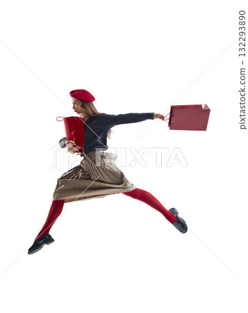 Fashion woman in red beret jumping with shopping bags and joyful motion isolated on white 132293890