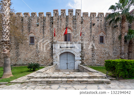 Okuz Mehmet Pasha Caravanserai, historic stone building with battlements and palm trees, Kusadasi, Turkey Okuz Mehmet Pasha Caravanserai, historic stone building with battlements and palm trees, Kusadasi, Turkey 132294042