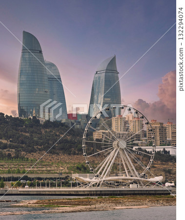 Baku, Azerbaijan cityscape featuring the iconic Flame Towers and Baku Ferris Wheel at sunset. Baku, Azerbaijan cityscape featuring the iconic Flame Towers and Baku Ferris Wheel at sunset. 132294074