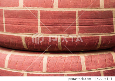 Painted tire surface with handmade brick texture closeup 132294121