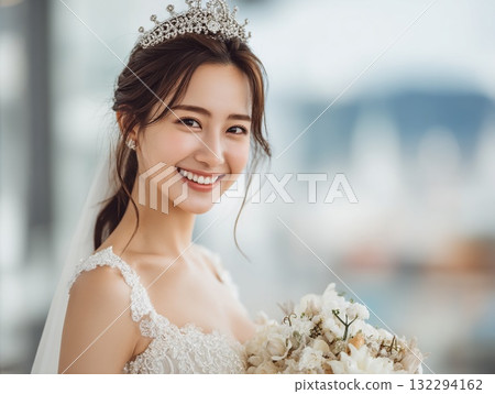 A wedding photo of a beautiful bride with a happy smile, a bouquet and a tiara. 132294162