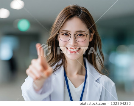 A female doctor points to the future with a smile, medical and health image A female doctor points to the future with a smile, medical and health image 132294223