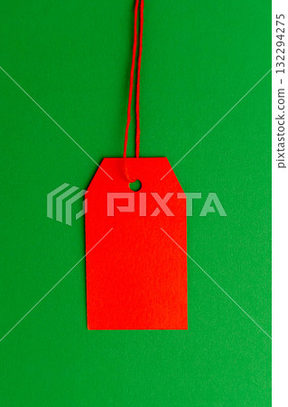 Red price tag on green background minimal composition 132294275