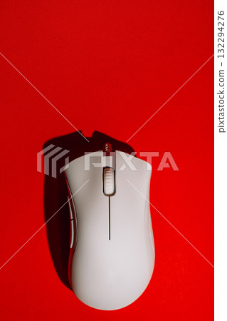 White wired gaming mouse on red background top view White wired gaming mouse on red background top view 132294276