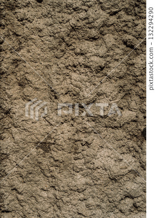 Macro texture of compacted gray mud or clay with irregular lumps and grit. Earthy, rough natural background. 132294290