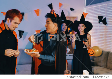 Joyful office Halloween party with coworkers in costumes, celebrating with drinks and laughter, fostering teamwork and festive spirit 132294576