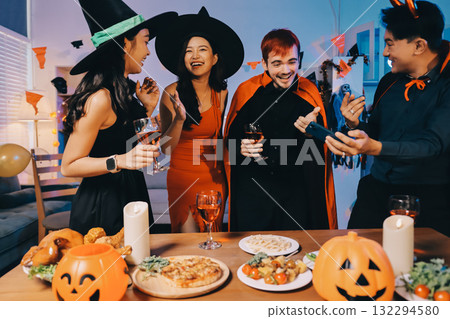 Joyful office Halloween party with coworkers in costumes, celebrating with drinks and laughter, fostering teamwork and festive spirit Joyful office Halloween party with coworkers in costumes, celebrating with drinks and laughter, fostering teamwork and festive spirit 132294580