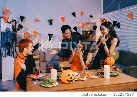 Joyful office Halloween party with coworkers in costumes, celebrating with drinks and laughter, fostering teamwork and festive spirit 132294597