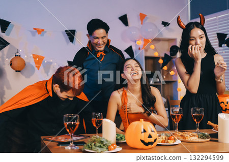Joyful office Halloween party with coworkers in costumes, celebrating with drinks and laughter, fostering teamwork and festive spirit Joyful office Halloween party with coworkers in costumes, celebrating with drinks and laughter, fostering teamwork and festive spirit 132294599