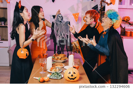 Joyful office Halloween party with coworkers in costumes, celebrating with drinks and laughter, fostering teamwork and festive spirit 132294606