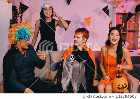 Joyful office Halloween party with coworkers in costumes, celebrating with drinks and laughter, fostering teamwork and festive spirit 132294608